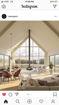 a living room filled with lots of furniture next to large windows covered in snow capped mountains