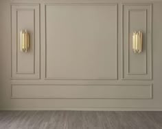 an empty room with white walls and gold handles on the doors is pictured in this image