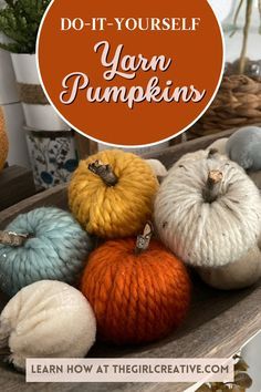 yarn pumpkins sitting on top of a wooden table with the words do - it - yourself your own pumpkins