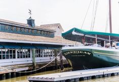 a boat is docked at the dock in front of a restaurant