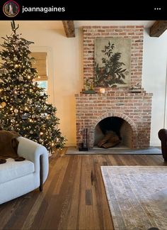 a living room filled with furniture and a christmas tree in front of a fire place