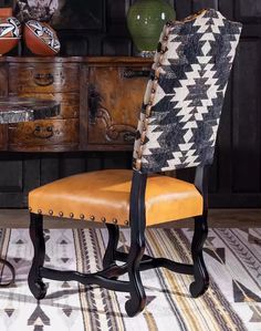 an upholstered chair sits in front of a wooden dresser with drawers on it