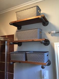 three shelves with baskets on them in a bathroom