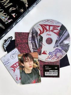 an image of a cd with various stickers on it and other items around it