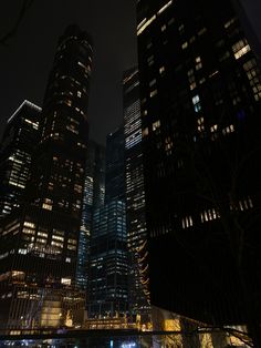 some very tall buildings at night time