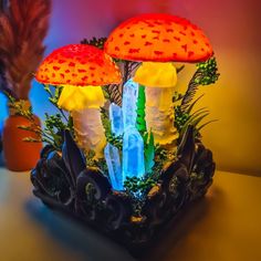 two colorful mushrooms sitting on top of a table