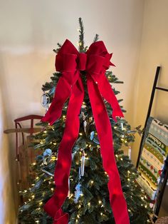 a christmas tree with a red bow on it