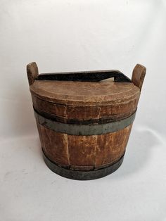 an old wooden barrel sitting on top of a white surface