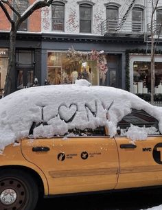 a taxi cab covered in snow with the word love written on it's windshield