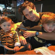 a man and two children sitting at a table