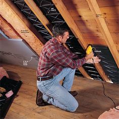 a man working on the ceiling in his attic