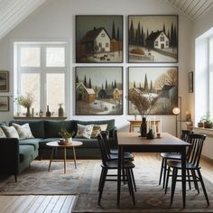 a living room filled with furniture and paintings on the wall above it's couches