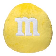 a yellow pillow with the letter m on it