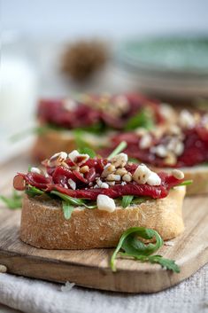 two pieces of bread topped with meat and vegetables