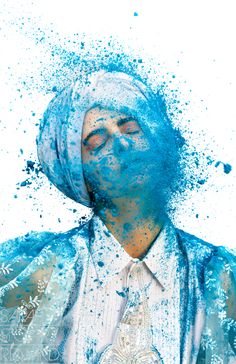 a man with blue paint on his face and neck, wearing a turban