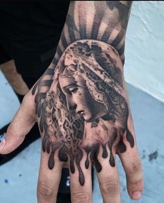 a person's hand with a tattoo on it