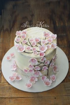 a white cake with pink flowers on top