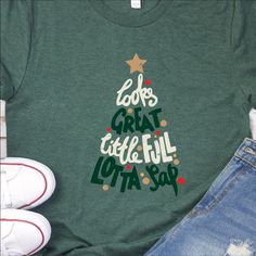 a t - shirt that says, looks great at christmas time with a tree on it