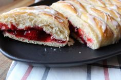 two pastries sitting on top of a black plate