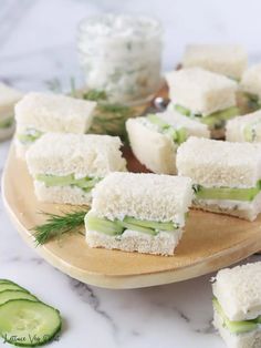 cucumber and cream cheese sandwiches on a plate