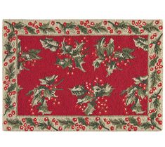 a red rug with holly and berries on it