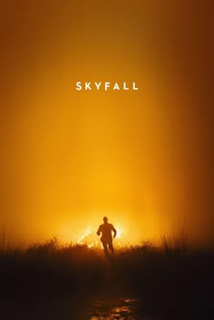 a movie poster for skyfall with the silhouette of a man running across a field