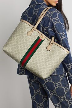 Gucci’s 'Love Parade' collection is filled with archival details and it doesn’t get more classic than the brand’s GG Supreme coated-canvas, which this 'Ophidia' bag is made from. Trimmed with leather, the pattern is broken up by the house’s web stripe and a hardware logo at the center. It’s carried by two handles and has a spacious interior with a zipped pocket for the smaller essentials. Gucci Outlet Handbags, Gucci Bags Outlet, Gucci Ophidia Bag, Luxurious Bags, Hardware Logo, Gucci Tote Bag, Gucci Ophidia, Stylish Purse, Gucci Tote