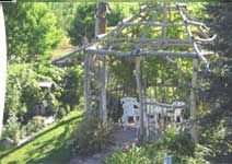 an outdoor gazebo surrounded by trees and bushes