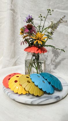 colorful flowers in a vase on a marble platter