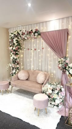 a living room filled with furniture and flowers on the wall next to a white rug