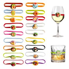 a wine glass and several different colored hair ties next to each other on a white background