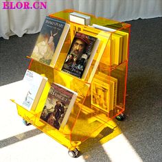 there is a yellow cart with books on it