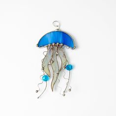 Such exquisite item of home decor as jellyfish suncatcher is the thing that will make your place of living more unique and cozy. In addition, stained glass jellyfish window hanging will be a perfect gift for someone special. Measurements: 6,5 inch (160 mm) This jellyfish suncatcher is created using L.C. Tiffany technique of copper foil. During the process of manufacturing stained glass goods, we use only the top-quality materials, such as:• 3 mm Spectrum Glass (USA) • Tin • Copper Foil• Black Pa Jellyfish Suncatcher, Glass Jellyfish, Pic Candle, Spectrum Glass, Mountain Pictures, Stained Glass Window Hanging, Stained Glass Suncatchers, Stained Glass Suncatcher, Mosaic Table