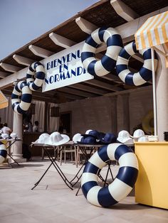 an outdoor restaurant with blue and white striped chairs