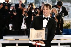 a man in a tuxedo holding an award