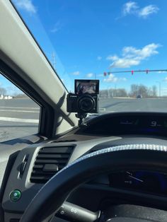 a car dashboard with a dash camera mounted to the front of it's windshield