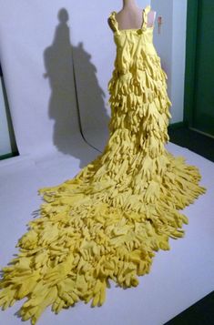 a dress made out of yellow feathers on display