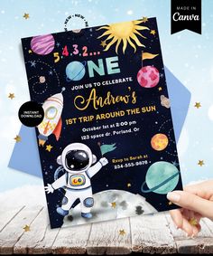 an astronaut birthday party is shown with space and stars on the background, as well as a hand holding up a card