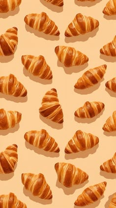 many croissants are arranged on a beige background