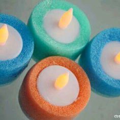 four colorful candles sitting on top of each other