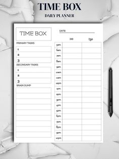 the time box is next to a pen on top of a piece of white paper