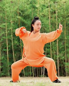 a woman in an orange outfit is doing yoga