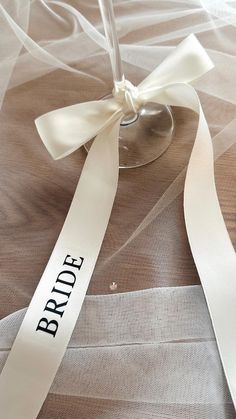 Elevate your special occasion with our personalised satin ribbon bows, perfect for place settings at weddings, hen parties, bridal showers, dinner parties, birthdays, and more. Our custom ribbons also make elegant additions to bridesmaid proposals, bridal party gifts on your wedding morning, or even as a stylish touch to your wedding reception drinks with your wedding logo featured.  PRODUCT DETAILS 🎀 Size: 250mm x 800mm Material: Premium double-faced satin Colour Options: Ivory, White, Black, Dusky Pink, Fuchsia Pink Font Options: Seven standard options to choose from HOW TO ORDER ✨ -Choose your ribbon color, font style, and font color. - For orders with fewer than 20 names, please list the names/roles in the personalisation box. For more than 20 names, email us the list, including your Extra Wedding Decorations, Hen Dinner Party, Hen Party Dinner, Wedding Morning Bridesmaids, Bow Themed Wedding, Black And White Hen Party, Wedding Gifts For Guests Elegant, Wedding Special Touches, Bridal Shower Place Settings