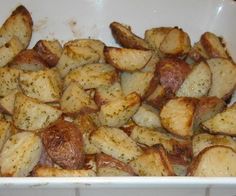 cooked potatoes with seasoning in a white bowl