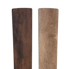 two pieces of wood sitting next to each other on a white background, one is brown and the other is black