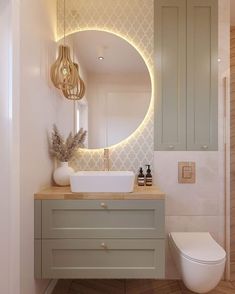 a bathroom with a white toilet and a round mirror on the wall next to it