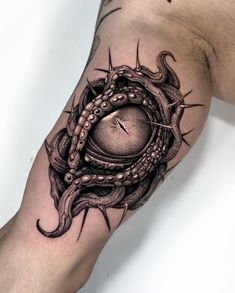 an octopus tattoo on the arm with a clock in it's center and tentacles