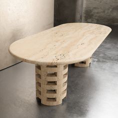 a wooden table sitting on top of a metal floor