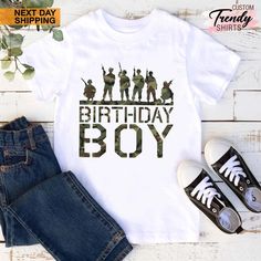 a birthday boy shirt with the silhouettes of soldiers on it, next to jeans and sneakers