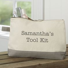 a white bag with the words savannah's tool kit on it sitting on a wooden table